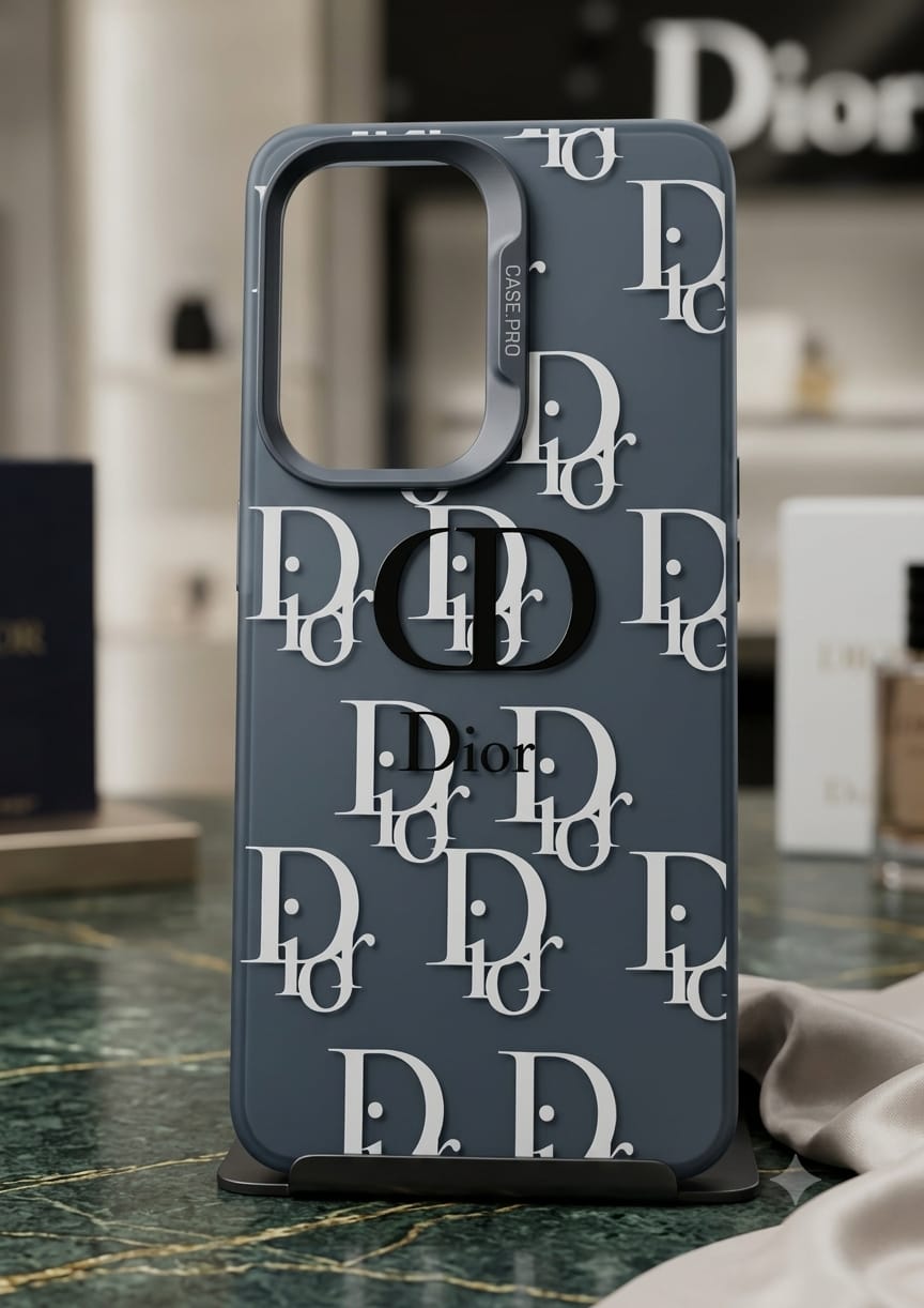 A dark slate blue Dior phone case with a repeating white 'Dior' monogram pattern, displayed on a marble surface with a blurred background.
